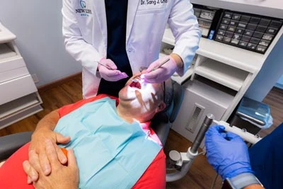 Dr. Sang Cho providing periodontal care to a patient at New Life Dental in Germantown, MD